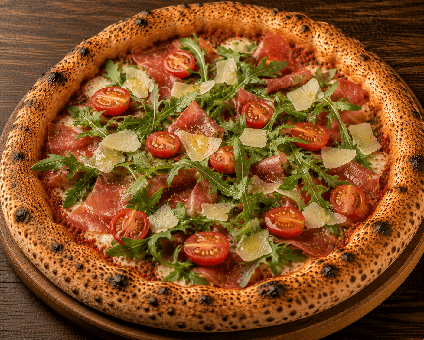 Pizza Speck - Sauce tomate, mozzarella, speck, roquette, copeaux de parmesan, huile d’olive, tomates fraîches